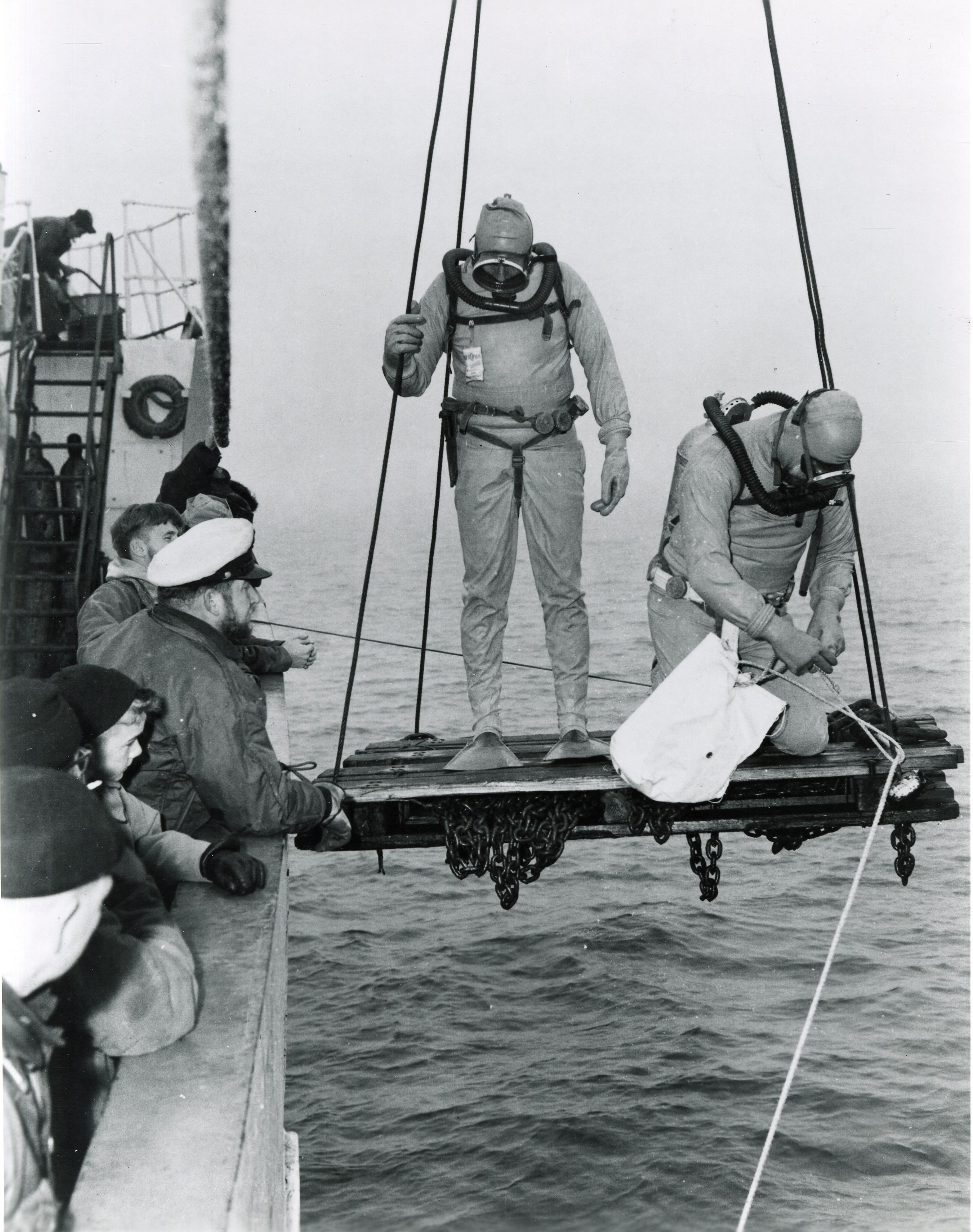 Divers serving with the 1957 Northwest Passage buoy tenders wearing an early form of dry suit. (U.S. Coast Guard) Divers serving with the 1957 Northwest Passage buoy tenders wearing an early form of dry suit. (U.S. Coast Guard)